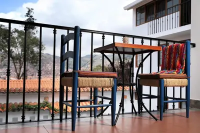 two chairs and a table on a balcony at Atoq San Blas Hotel in Cusco