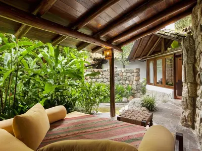 an outdoor living room with a wooden ceiling at Inkaterra Machu Picchu Pueblo Hotel in Machu Picchu