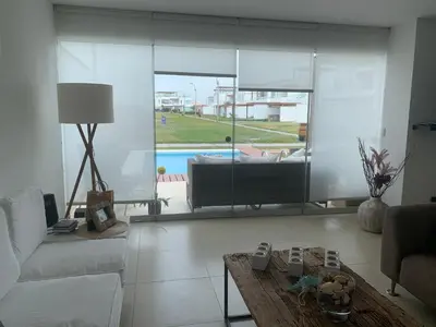 a living room with a couch and a coffee table at Condominios Nauticos Nuevo Paracas in Paracas