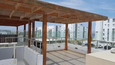 a view from the balcony of a apartment with a wooden roof at Condominios Nauticos Nuevo Paracas in Paracas