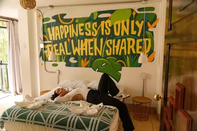 a woman laying on a bed in a room at Supertramp Hostel Machupicchu in Machu Picchu