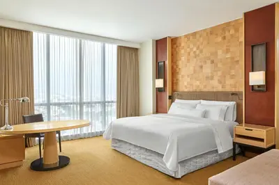 a hotel room with a large bed and a table at The Westin Lima Hotel & Convention Center in Lima