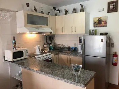 a kitchen with a refrigerator and a microwave at A Perfect Vacation Getaway Apartment in Lima