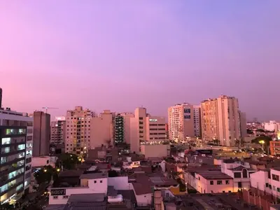 a city skyline at night with tall buildings at A Perfect Vacation Getaway Apartment in Lima
