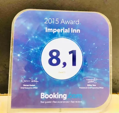a sign that says annual imperial inn with a clock at Imperial Inn Hospedaje Turistico in Lima