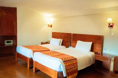 a hotel room with two beds in a room at Siete Ventanas in Cusco