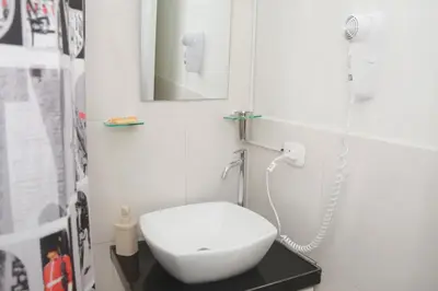 a bathroom with a white toilet and a mirror at Barranco Wasi in Lima