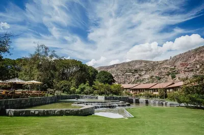 a view of a park with a river and mountains at Tambo del Inka, a Luxury Collection Resort & Spa, Valle Sagrado in Urubamba