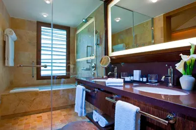 a large bathroom with a sink and a shower at Tambo del Inka, a Luxury Collection Resort & Spa, Valle Sagrado in Urubamba