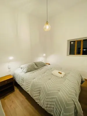 a bedroom with a bed and a table and a window at Flying Dog Hostel Cusco in Cusco