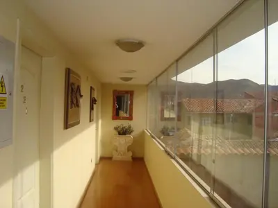 a hallway with a view of a house with a window at Taypikala Hotel Cusco in Cusco