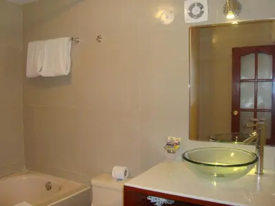 a bathroom with a sink and a tub and a toilet at Taypikala Hotel Cusco in Cusco