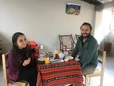 a man and a woman sitting at a table at Hostal Apu Qhawarina in Ollantaytambo