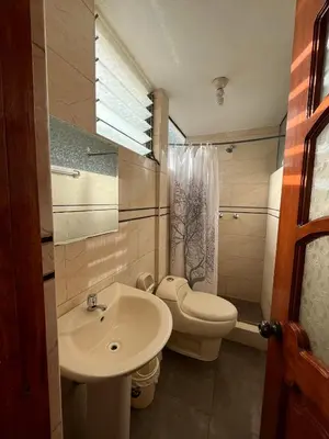 a bathroom with a toilet and a sink at Hostal Apu Qhawarina in Ollantaytambo