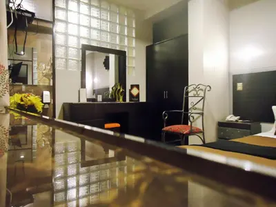 a room with a mirror and a bed and a chair at Hotel San Francisco Plaza in Cusco
