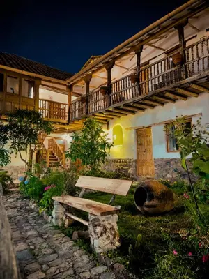 a house with a bench in the yard at El Balcón in Cusco