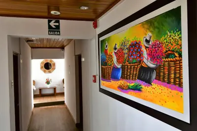 a hallway with a large painting on the wall at Centenario Inn in Cusco