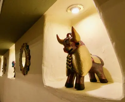 a statue of an elephant sitting on a shelf at Sol Ollantay Boutique Hotel in Ollantaytambo