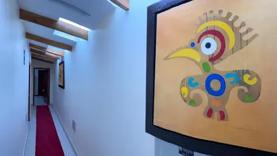 a painting of a turkey on the wall of a hallway at Sol Ollantay Boutique Hotel in Ollantaytambo