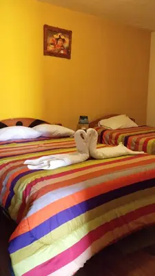 two beds sitting next to each other in a room at Casa Salkantay Cusco in Cusco