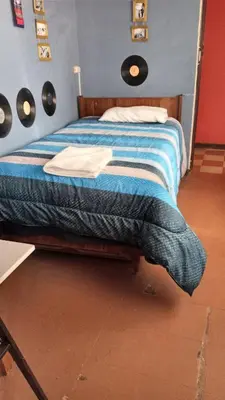 a bedroom with a bed with a blue comforter at Casa Salkantay Cusco in Cusco