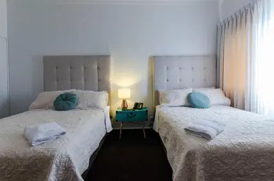 two beds sitting next to each other in a bedroom at Jose Luis Hostal Boutique in Lima
