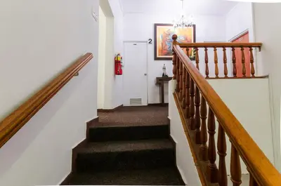 a hallway with stairs with a fire hydrant on the wall at Jose Luis Hostal Boutique in Lima