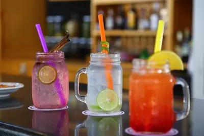 three drinks in mason jars sitting on a counter at Hotel Las Dunas in Ica
