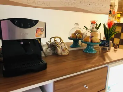 a counter with a coffee maker on top of a desk at Hostal Patiño in Lima