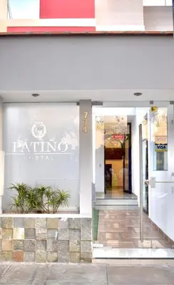 a store front with a sign on the window at Hostal Patiño in Lima
