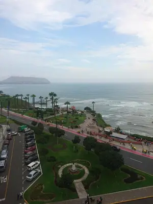 an aerial view of a parking lot next to the ocean at Malecón in Lima