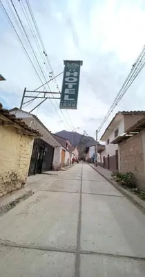 an empty street with a sign hanging over it at Hotel Quilla in Urubamba