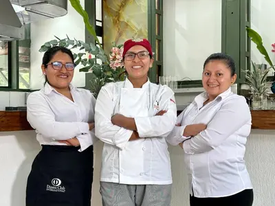 three women standing in a kitchen with their arms crossed at Hatun Inti Classic in Machu Picchu