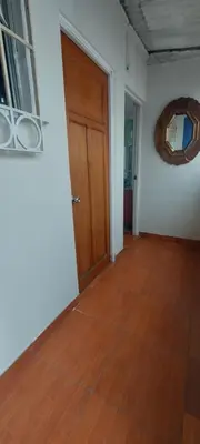 a room with a wooden door and a wooden floor at Habitación con baño privado acceso a cocina y terraza en Miraflores in Lima