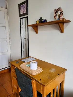 a wooden table with a cup on top of it at Habitación con dos camas, baño privado, terraza y cocina compartida en Miraflores in Lima