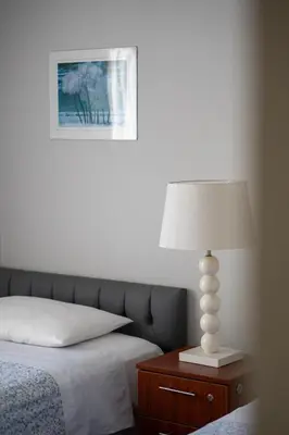 a bedroom with a bed and a lamp on a nightstand at Departamento en San Isidro, Lima in Lima
