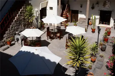 an overhead view of a patio with tables and umbrellas at Unaytambo Boutique Hotel Cusco in Cusco