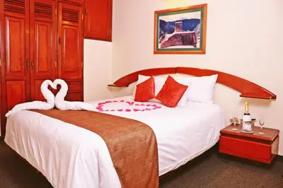 a bedroom with a bed with a swan on it at Apart Hotel Caminos del Inca in Lima