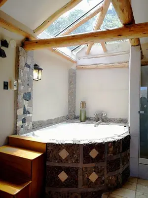 a bathroom with a bath tub with a window at Cities of the World - Apartments Cusco in Cusco