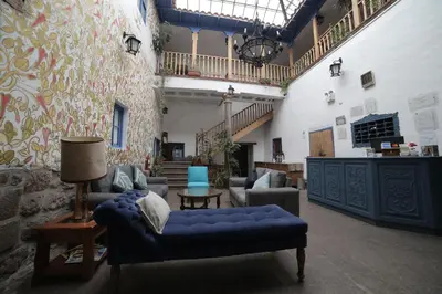 a living room with a couch and a table at Posada Villa Mayor in Cusco
