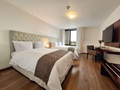 a hotel room with a large bed and a television at NM Lima Hotel in Lima