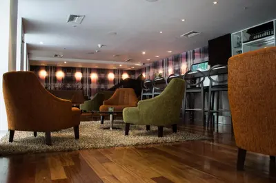 a waiting room with chairs and a table at NM Lima Hotel in Lima