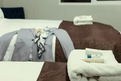a pile of towels on top of a bed at Hotel Unu in Huancayo