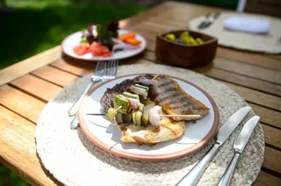 two plates of food on a wooden table at Las Casitas del Arco Iris in Urubamba