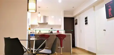 a kitchen with a table and chairs in a room at GL Apts, rent Upper Pardo Miraflores - Suite 1 Hab in Lima