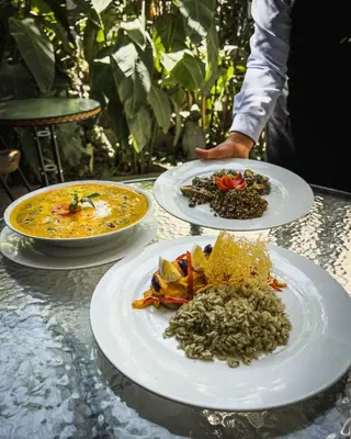three plates of food on top of a table at El Albergue Ollantaytambo in Ollantaytambo