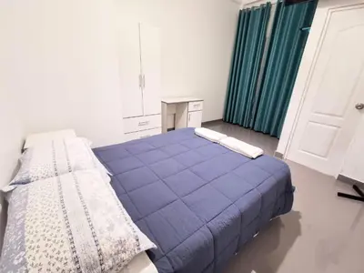a bedroom with a blue bed in a room at AQUAMARINE PARACAS Beach Hostal in Paracas