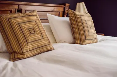 two pillows sitting on top of a white bed at Ana Frank Boutique Hotel in Lima