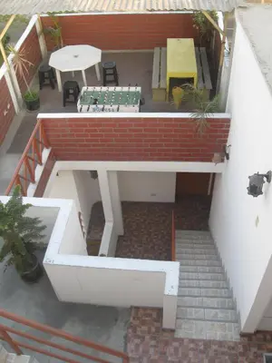 an overhead view of a patio with a table and chairs at Posada Peregrinus in Lima