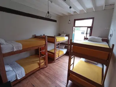 a room with four bunk beds and a window at Flying Dog Lima B&B in Lima